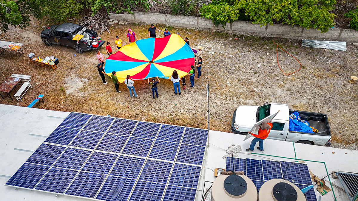 Workers outside by solar panels