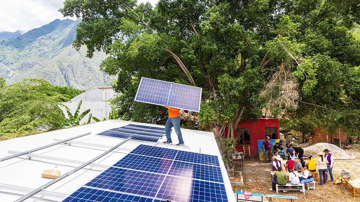 A worker carrying a solar panel